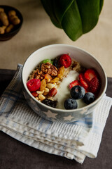Beautiful breakfast oatmeal with yogurt and berries, nuts