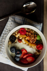 Beautiful breakfast oatmeal with yogurt and berries, nuts