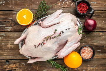 Fresh raw whole duck ready for cooking on a wooden background, Culinary cooking. banner, menu, recipe place for text, top view