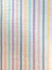 The texture of the fabric. White sheet in multi-colored lines. Cotton, linen, calico. Striped background.
