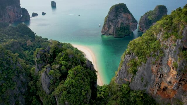 Aerial view through the lush jungle of Krabi of the beautiful Phra Nang Cave Beach without people, Thailand