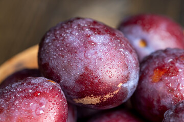 Ripe delicious plums of dark color
