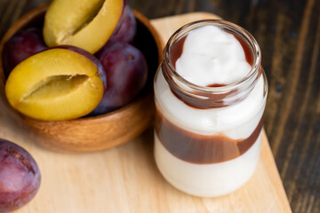 Ripe dark - colored plums sliced on the table