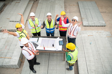 Construction engineers, architects, and foremen form a group. Participate in a meeting to plan new construction projects.