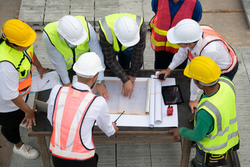 Construction engineers, architects, and foremen form a group. Participate in a meeting to plan new...