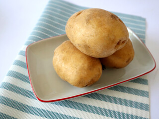 fresh large potatoes on a plate