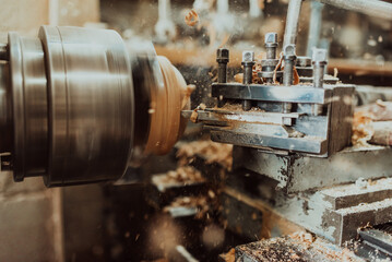 Close-up photo of a lathe working on wood. Mechanical processing of wood