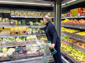 Woman buying fruits and vegetables at the market