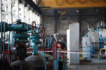 Almaty, Kazakhstan - 10.07.2022 : Pipes, valves and pressure sensors in the generator room at the heating plant.