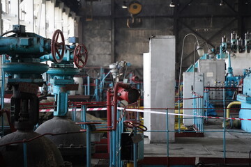 Almaty, Kazakhstan - 10.07.2022 : Pipes, valves and pressure sensors in the generator room at the heating plant.