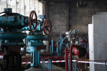 Almaty, Kazakhstan - 10.07.2022 : Pipes, valves and pressure sensors in the generator room at the heating plant.