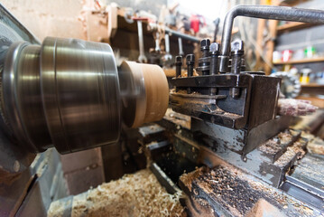Close-up photo of a lathe working on wood. Mechanical processing of wood