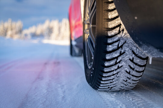 Winter tyre of car driving on slippery road in the snowy forest, Kangos, Norrbotten County, Lapland, Sweden, Scandinavia, Europe
