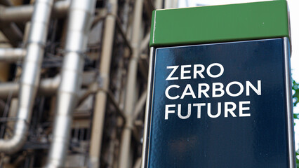 Fototapeta Zero Carbon Future on a sign in front of an Industrial building	 obraz