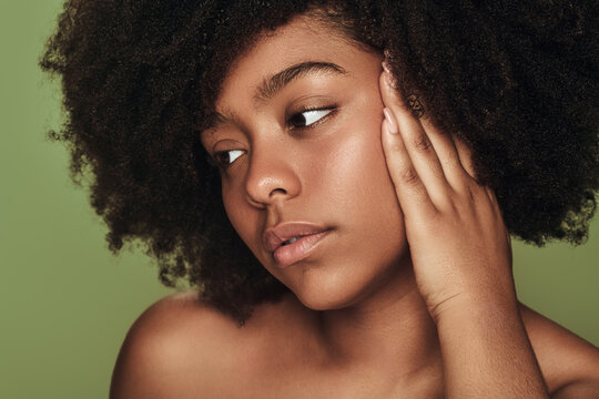 Black woman touching face clean skin
