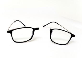Broken reading glasses on white background - 569616707