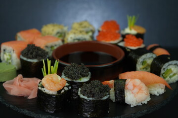 Set of sushi on a black plate. Japanese food Roll Maki Sushi with Wasabi, Caviar