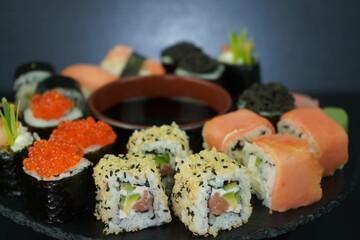 Set of sushi on a black plate. Japanese food Roll Maki Sushi with Wasabi, Caviar