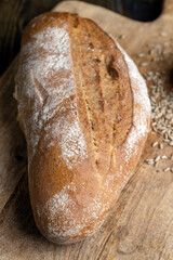 A whole freshly baked loaf of dark bread