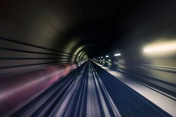 Railroad track in underground tunnel in blurred motion. Point of view from train..