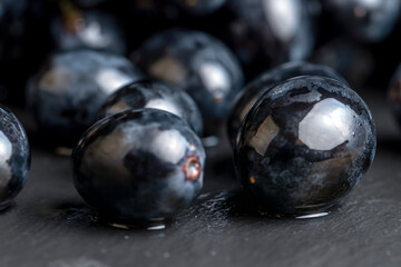 washed ripe black grapes covered with drops of water