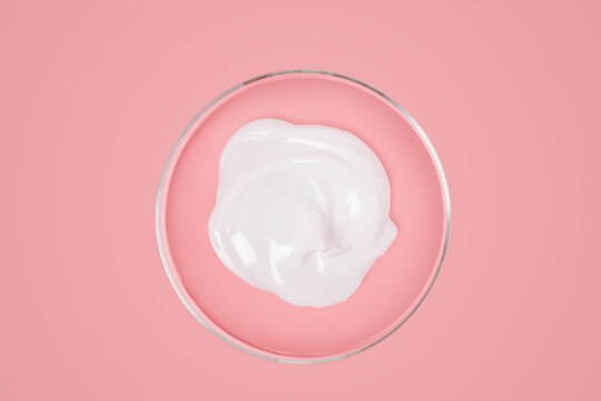 Cream Of White Color In A Petri Dish On A Pink Background. View From Above