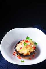 Healthy food concept bake Cheese Stuffed Mushrooms on black background with copy space