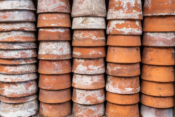 Clay pots. Stacks of old pots. ceramic dishes for flowers. Flower stock. Used items for recycling or reuse. Ceramic pots are stacked.
