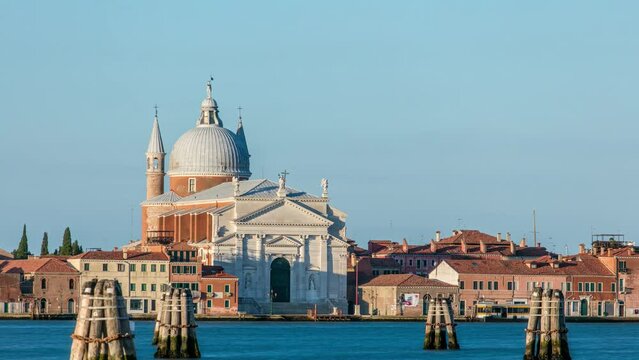 Lagoon of Venice with Chiesa church del Santissimo Redentore located on Giudecca island in the sestiere of Dorsoduro timelapse. Warm light early morning after sunrise