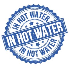 Fototapeta premium IN HOT WATER text on blue round stamp sign
