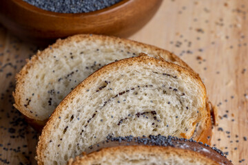 Poppy seeds and a bun with poppy seeds on the table