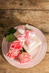 Romantic dinner table on rustic background. Love cutlery for Valentine's or Mother's day, Wedding