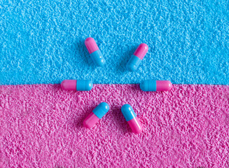 flower from pink and blue pills on pink and blue background. Pregnancy conception. Girl or boy