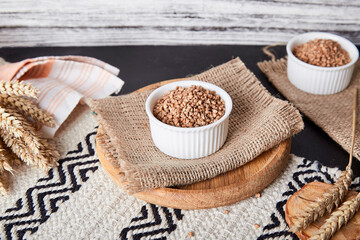 Organic buckwheat porridge - healthy superfood with cutlery made of natural cotton and wood.