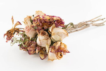 On a light background, a bouquet of dried roses and tulips.
