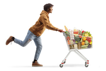 Full length profile shot of a young african american man running with a shopping cart © Ljupco Smokovski