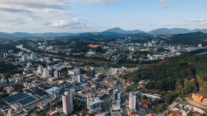 Fototapeta na wymiar aerial image of downtown Blumenau, with Itajaí Açú River, Santa Catarina, southern Brazil, buildings, main streets, vegetation and sunny day