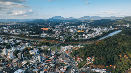 aerial image of downtown Blumenau, with Itajaí Açú River, Santa Catarina, southern Brazil, buildings, main streets, vegetation and sunny day