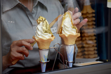 Vanilla soft ice cream on a cone with a thin leaf of gold famous in Kanagawa city, Japan. Delicious...