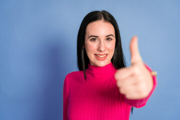 Smiling woman showing thumbs up