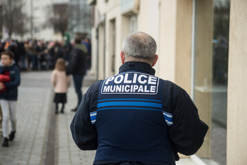 Riedisheim  - France - 6 February 2023 - Portrait on back view of french police man walking in the street - 569643399