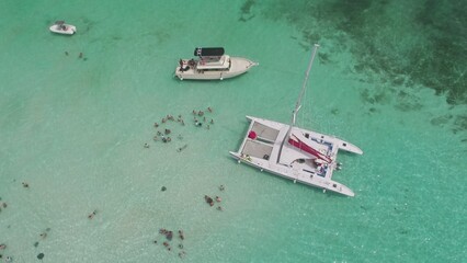 Aerial view of tourists on yachts and tour boats in sting ray city in Cayman Islands in shallow turquoise water