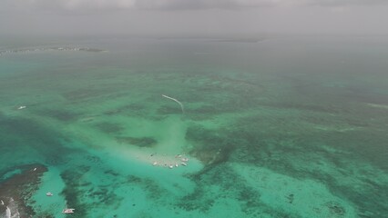 Naklejka premium High aerial view of yachts and tour boats in sting ray city in Cayman Islands in shallow turquoise water
