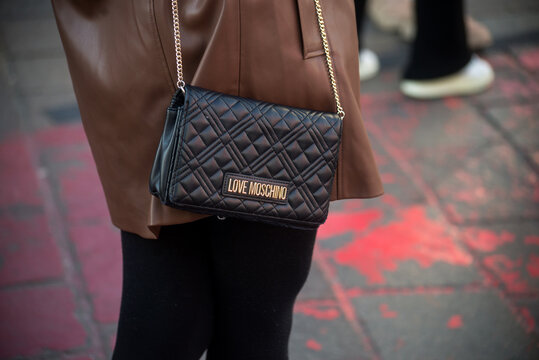 Mulhouse - France - 7 February 2023 - Closeup of young woman with a moschino hand bag standing in the street