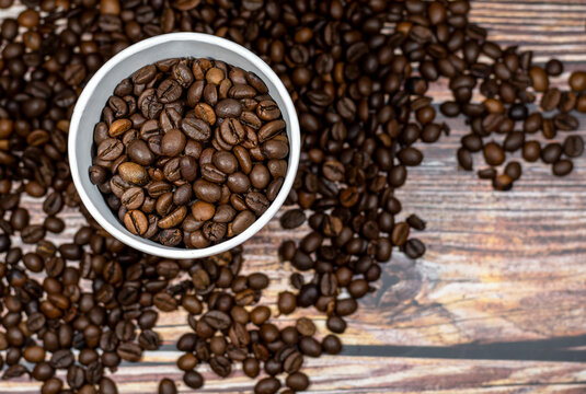 Paper cup of coffee on the background of coffee beans top view. Paper coffee cup with coffee beans