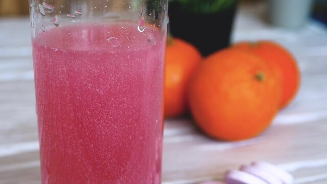 Close-up Vitamin pop with water. The concept of drinking vitamin C in tablets. Fruit juice or freshly squeezed. Medicinal fruit tablets against beriberi in the human body.