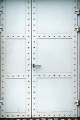 Metal door with grey rivets without keyhole