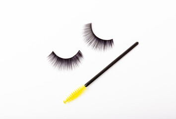 Mascara brushes, makeup brushes, applicators and false eyelashes isolated on white background. Close-up. Brushes for eyelash extensions.