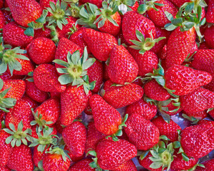 Bright red, fresh strawberries top view close-up. Juicy vegan food background.