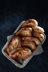 Bread in the form of tortillas. Wheat flour tortillas. Bread in a basket on a dark background.Flat lay.Top view.Copy space.